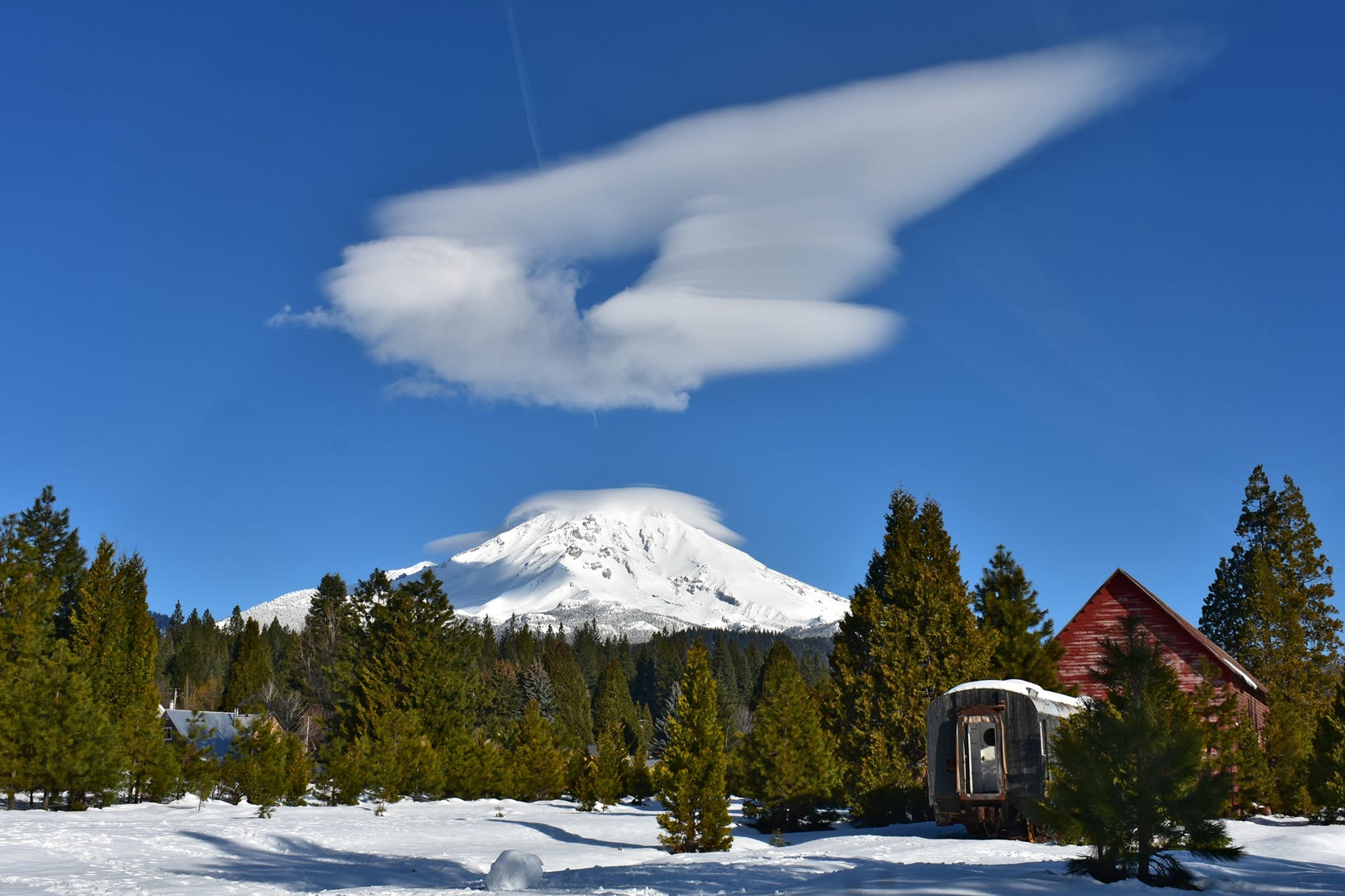 An interesting lenticular formation over a snow-covered Mt. Shasta, as seen from McCloud.