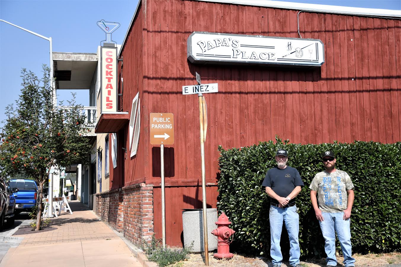 Dave Culbertson and Daniel Anderson stand in front of Papa's Place on Weed's Main Street, which has closed its doors for good.