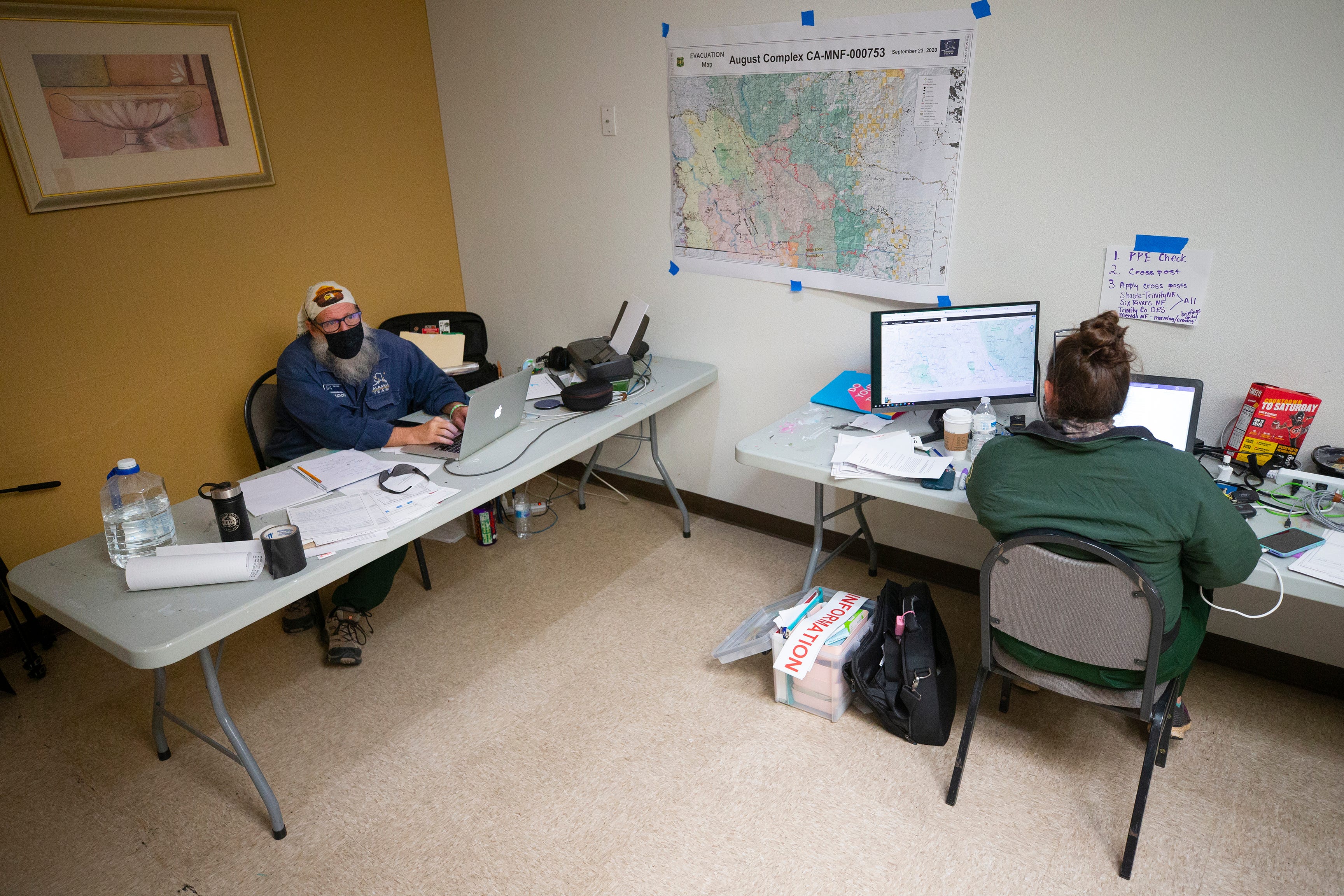 Sam Harrel,  Alaska Incident Management team PIO, and Amelia Fleitz, PIO in training with the U.S. Forest Service, work to get the information out on the August Complex North fire, out of the Holiday Inn Redding on Sept. 25, 2020.