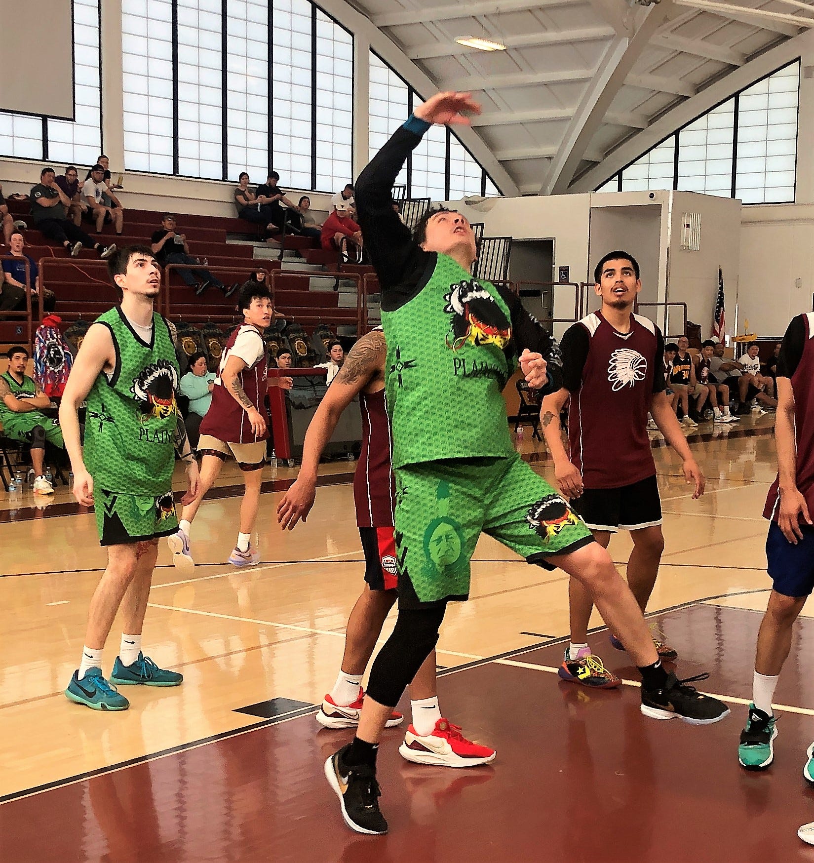 Plainzmen forward and Turtle Mountain Band of Chippewa Indians tribe member Donald Gunville Jr. (center) puts up a shot near the basket during the 60th All Indian Hoopa Valley Basketball Tournament on Sunday, April 23, 2023.